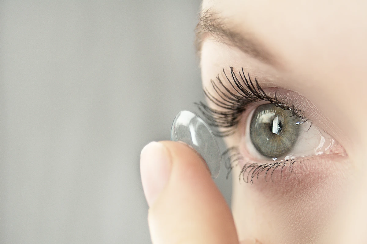 contact-lens-close-up close-up of person placing contact lens on eye